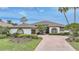 Charming one-story home with a tile roof, mature landscaping, and a brick driveway at 4532 Chase Oaks Dr, Sarasota, FL 34241