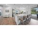 An open-concept kitchen with a breakfast bar, granite countertops, stainless appliances, and pool views at 4532 Chase Oaks Dr, Sarasota, FL 34241
