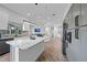 Bright kitchen showcasing a large island, custom cabinets, stainless steel appliances, and hardwood floors at 4532 Chase Oaks Dr, Sarasota, FL 34241