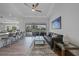 Bright living room featuring modern decor, a ceiling fan, and sliding glass doors to the lanai at 4532 Chase Oaks Dr, Sarasota, FL 34241