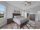Inviting main bedroom with tray ceilings, a ceiling fan, and hardwood floors throughout at 4532 Chase Oaks Dr, Sarasota, FL 34241