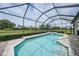 A screened-in pool and spa offer serene outdoor enjoyment with views of the lush green golf course and landscaped grounds at 4532 Chase Oaks Dr, Sarasota, FL 34241