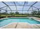 A screened-in pool and spa offer serene outdoor enjoyment with views of the lush green golf course and landscaped grounds at 4532 Chase Oaks Dr, Sarasota, FL 34241