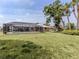 Spacious backyard with a screened-in pool enclosure, mature trees and a well-maintained lawn at 455 Rubens E Dr, Nokomis, FL 34275