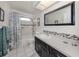 Modern bathroom with a shower-tub combo and tile accents at 455 Rubens E Dr, Nokomis, FL 34275
