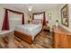 Comfortable bedroom with wood floors and natural light at 455 Rubens E Dr, Nokomis, FL 34275