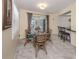 Cozy dining area with a glass table, seating for four, and natural light at 455 Rubens E Dr, Nokomis, FL 34275