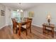 Elegant dining area with a wooden table set and chandelier lighting at 455 Rubens E Dr, Nokomis, FL 34275