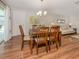 Cozy dining area with wood floors and an adjacent living room, perfect for gatherings at 455 Rubens E Dr, Nokomis, FL 34275