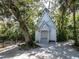 Quaint white chapel surrounded by trees, beside a gravel driveway at 455 Rubens E Dr, Nokomis, FL 34275