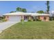 Charming single-story home with a white tile roof, lush lawn, and inviting curb appeal at 455 Rubens E Dr, Nokomis, FL 34275