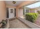 Welcoming screened front porch featuring a decorative door and tiled floor at 455 Rubens E Dr, Nokomis, FL 34275