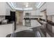 Modern kitchen with white cabinets, granite countertops, and stainless steel appliances at 455 Rubens E Dr, Nokomis, FL 34275