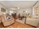 Open-concept living room and dining area with wood floors and lots of natural light at 455 Rubens Dr, Nokomis, FL 34275