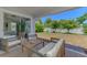 Comfortable seating on a screened in back porch overlooking the backyard and lush landscaping at 4624 Caribou Ave, North Port, FL 34287