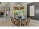 Cozy dining area with a round table, wicker chairs, and natural light from the window at 4624 Caribou Ave, North Port, FL 34287