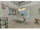 Elegant dining room featuring modern light fixture and large windows for ample natural light at 4624 Caribou Ave, North Port, FL 34287