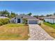 Beautiful single-Gathering home showcasing a long brick driveway, attached garage, and lovely landscaping at 4624 Caribou Ave, North Port, FL 34287