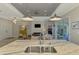 Modern kitchen island featuring stainless steel sink, marble countertops, and open view to living room at 4624 Caribou Ave, North Port, FL 34287