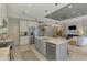 Open-concept kitchen with a marble island, stainless steel appliances, and view into the living room at 4624 Caribou Ave, North Port, FL 34287