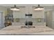 Close-up of the kitchen island featuring a marble countertop, modern faucet, and bright lighting at 4624 Caribou Ave, North Port, FL 34287