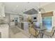 Open kitchen with stainless appliances, marble countertops, and view to dining and living areas at 4624 Caribou Ave, North Port, FL 34287