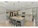 Bright kitchen featuring a marble island, modern lighting, stainless steel appliances, and white cabinets at 4624 Caribou Ave, North Port, FL 34287