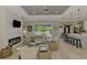 Inviting living room featuring a cozy fireplace, modern ceiling fan, and plenty of natural light at 4624 Caribou Ave, North Port, FL 34287