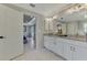 The main bathroom opens to the main bedroom and features double sinks and granite countertops at 4624 Caribou Ave, North Port, FL 34287