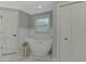 Bathroom featuring a standalone tub, marble floors, and a window at 4624 Caribou Ave, North Port, FL 34287