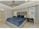 Cozy main bedroom featuring a blue bed, tray ceiling, and modern decor at 4624 Caribou Ave, North Port, FL 34287