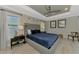 Comfortable main bedroom with a blue bed, tray ceiling, and neutral decor at 4624 Caribou Ave, North Port, FL 34287