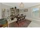 Home office with a large window, modern light fixture, and shelving at 4624 Caribou Ave, North Port, FL 34287