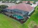 Aerial shot of a home with a screened-in pool and landscaped backyard at 515 Sawgrass Bridge Rd, Venice, FL 34292