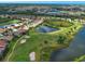 Aerial view of a home with a private pond and golf course in a lush community at 515 Sawgrass Bridge Rd, Venice, FL 34292