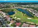 Aerial view showcases golf course community, pond, and verdant landscaping at 515 Sawgrass Bridge Rd, Venice, FL 34292