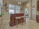 The wet bar area features custom wood work and plenty of natural light at 515 Sawgrass Bridge Rd, Venice, FL 34292