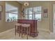 View of the custom bar area shows plenty of natural light and seating for two at 515 Sawgrass Bridge Rd, Venice, FL 34292