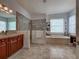 Bathroom with a large walk-in shower, vanity, and soaking tub under a window at 515 Sawgrass Bridge Rd, Venice, FL 34292