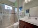 Elegant bathroom features a tiled shower with a glass door and earth-toned tile accents at 515 Sawgrass Bridge Rd, Venice, FL 34292