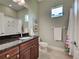 Well-lit bathroom with a dark vanity, neutral color scheme, and shower at 515 Sawgrass Bridge Rd, Venice, FL 34292