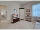 Inviting bedroom boasts tv, storage, and access to other rooms at 515 Sawgrass Bridge Rd, Venice, FL 34292
