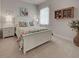 Charming bedroom boasts a floral bedspread, side tables, and soft natural light at 515 Sawgrass Bridge Rd, Venice, FL 34292