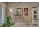 Inviting foyer with a marble-top table, decorative mirror, and elegant decor at 515 Sawgrass Bridge Rd, Venice, FL 34292