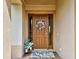 Inviting front door with a decorative wreath, potted plants, and a stylish welcome mat at 515 Sawgrass Bridge Rd, Venice, FL 34292