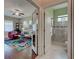 Hallway featuring hardwood floors, access to the living room, and entry to the bathroom at 515 Sawgrass Bridge Rd, Venice, FL 34292