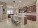 Bright, open kitchen featuring a breakfast bar, custom cabinets, and stainless steel appliances at 515 Sawgrass Bridge Rd, Venice, FL 34292