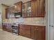 Beautiful kitchen boasting custom wood cabinetry with glass-fronts and stainless steel appliances at 515 Sawgrass Bridge Rd, Venice, FL 34292