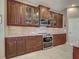 Well-equipped kitchen featuring custom cabinetry, granite countertops, and modern stainless steel appliances at 515 Sawgrass Bridge Rd, Venice, FL 34292