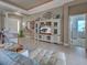 Bright living room with tile flooring, elegant decor, and a large entertainment center at 515 Sawgrass Bridge Rd, Venice, FL 34292